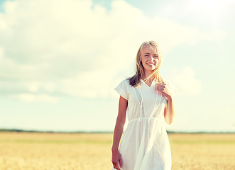 Image showing happy young woman or teenage girl on cereal field