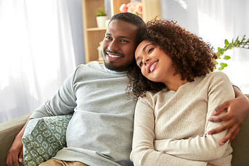 Image showing happy african american couple hugging at home