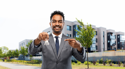 Image showing indian man realtor with home keys on city street