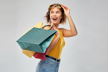 Image showing happy smiling young woman with shopping bags