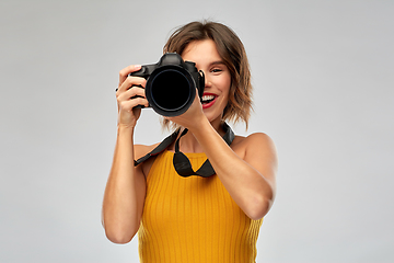 Image showing happy woman photographer with digital camera