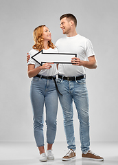Image showing happy couple in white t-shirts with arrow to left