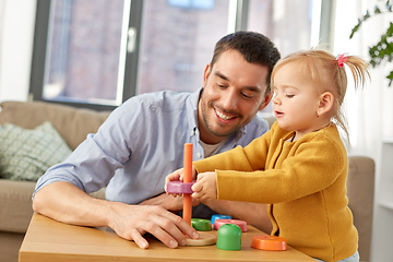 Image showing father playing with little baby daughter at home