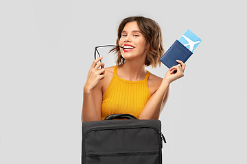 Image showing happy young woman with air ticket and travel bag