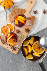 Image showing pot with hot mulled wine, orange slices and spices