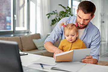 Image showing working father with baby daughter at home office