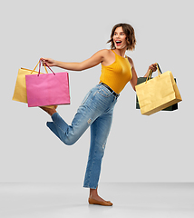 Image showing happy smiling young woman with shopping bags