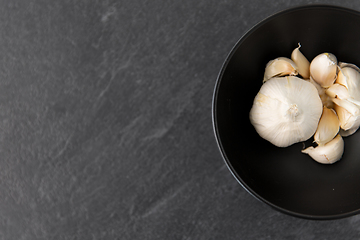 Image showing garlic in bowl on slate stone background