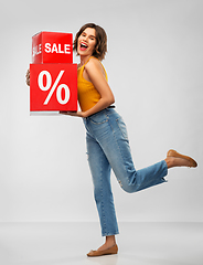Image showing happy smiling young woman with sale signs