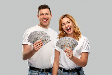 Image showing happy couple in white t-shirts with dollar money