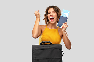 Image showing happy young woman with air ticket and travel bag