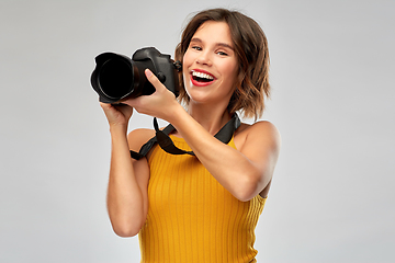 Image showing happy woman photographer with digital camera