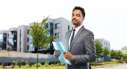 Image showing indian man realtor with folder on city street