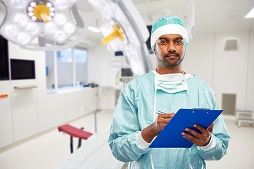 Image showing indian male surgeon with clipboard at hospital