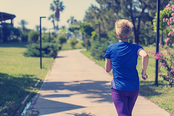 Image showing young female runner training for marathon