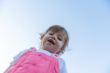 Image showing little girl spending time at backyard