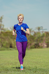 Image showing young female runner training for marathon