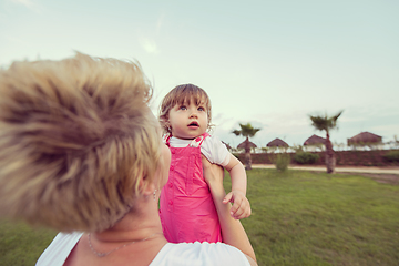 Image showing mother and little daughter playing at backyard