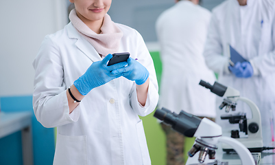 Image showing woman scientist using smartphone