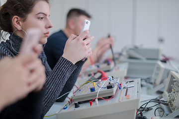 Image showing female student using a mobile phone