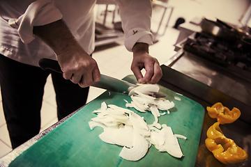 Image showing Chef hands cutting fresh and delicious vegetables