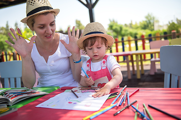 Image showing mom and little daughter drawing a colorful pictures