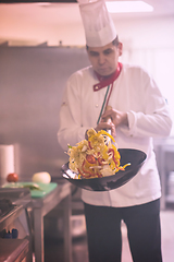 Image showing chef flipping vegetables in wok