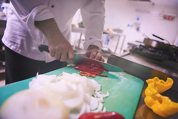 Image showing Chef hands cutting fresh and delicious vegetables