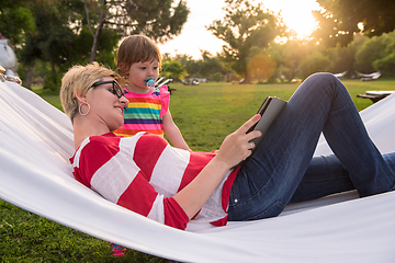 Image showing mom and a little daughter relaxing in a hammock