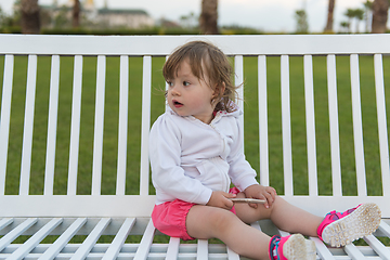 Image showing little girl playing with mobile phone