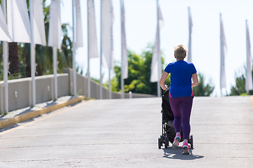 Image showing mom with baby stroller jogging