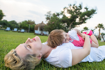 Image showing mother and little daughter playing at backyard