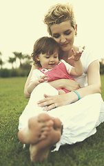 Image showing mother and little daughter playing at backyard