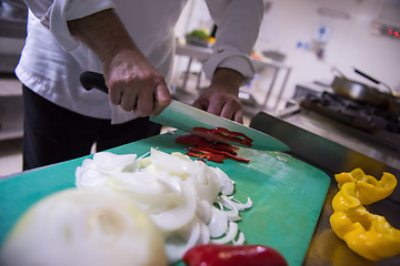 Image showing Chef hands cutting fresh and delicious vegetables