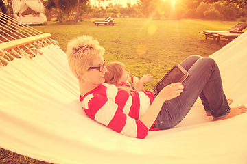 Image showing mom and a little daughter relaxing in a hammock