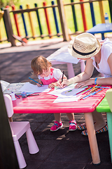 Image showing mom and little daughter drawing a colorful pictures