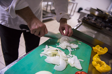 Image showing Chef hands cutting fresh and delicious vegetables