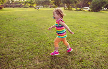 Image showing little girl spending time at backyard