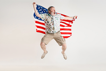 Image showing Senior man with the flag of United States of America