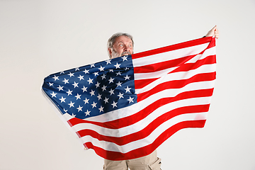 Image showing Senior man with the flag of United States of America