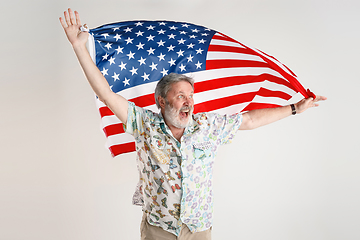 Image showing Senior man with the flag of United States of America