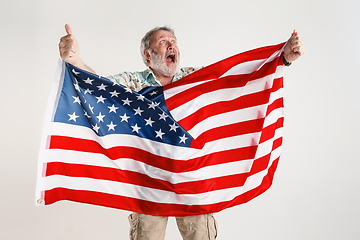 Image showing Senior man with the flag of United States of America