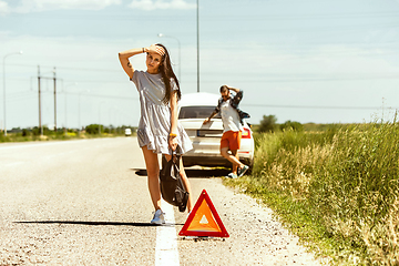 Image showing Young couple traveling on the car in sunny day