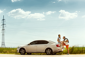 Image showing Young couple traveling on the car in sunny day