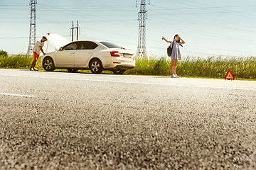 Image showing Young couple traveling on the car in sunny day