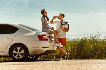 Image showing Young couple traveling on the car in sunny day