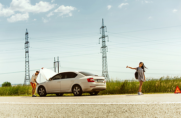 Image showing Young couple traveling on the car in sunny day