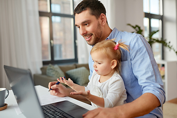 Image showing working father with baby daughter at home office