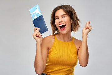 Image showing happy young woman with air ticket and passport