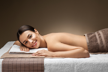 Image showing young woman lying at spa or massage parlor